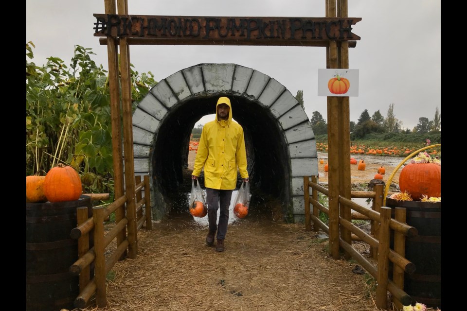 A happy visitor leaving the pumpkin patch with his chosen pumpkins.