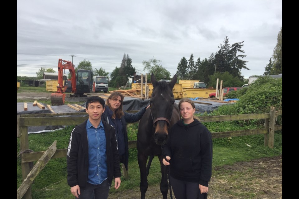 Landowner David Kao (left) and horse riding instructor Janice Foley (second left) claim their new neighbour on Steveston Highway, close to No. 6 Road, is causing all kinds of noise pollution and is spooking the horses