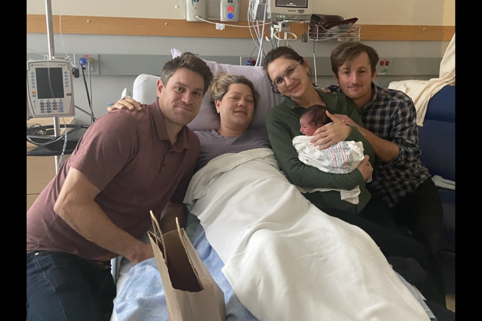 Katya Ballos (second right), her husband Jason Trigg (right) with baby Milo and the Eller family