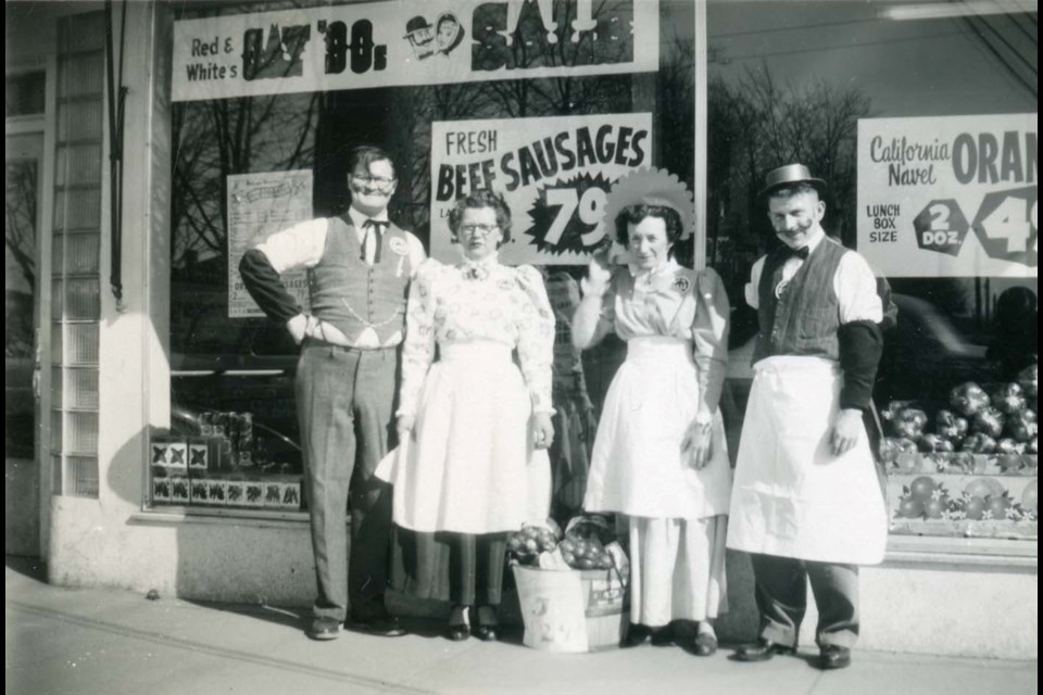 The owners and staff at the Brighouse Red & White Grocery Store pose for a photo in 1960 as part of its "gay '90s" sale
