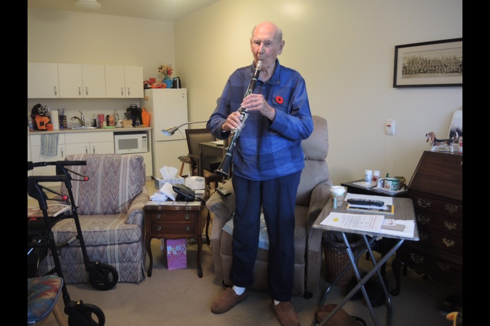 100-year-old Richmond resident Bud Kellet plays the clarinet in his Maples Residences home in Steveston          