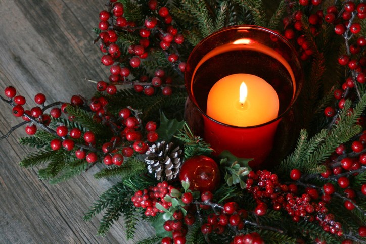 Christmas Candle and holly on a table