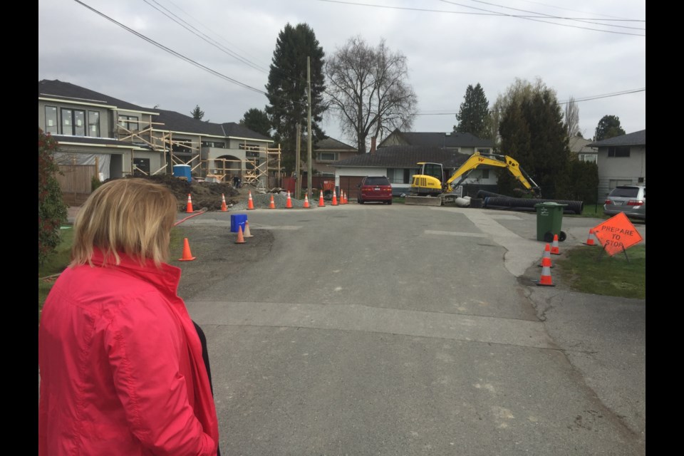 Richmond resident Kerry Starchuk looks on at the building site that her formerly quiet cul de sac has become