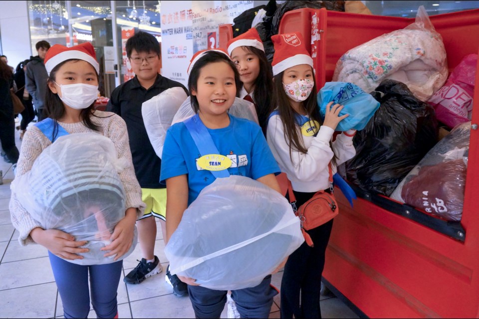 Little Sunshine finalists collecting used clothing items for the Salvation Army.
