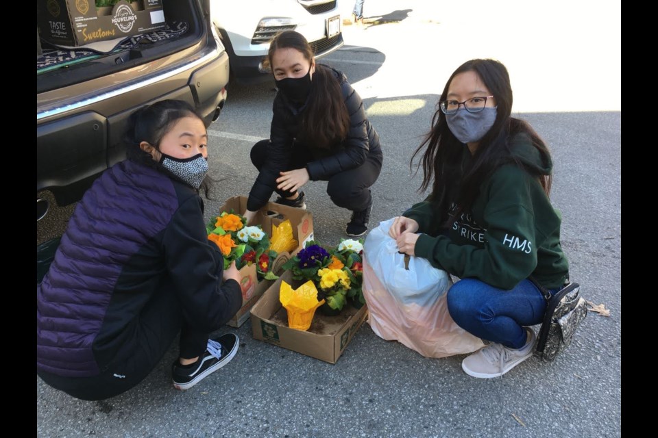 McRoberts students Iris Gu, Emma Pohl and Keira Lee represented their student club to deliver flowers and cards to Richmond's Gilmore Gardens Retirement Residence.