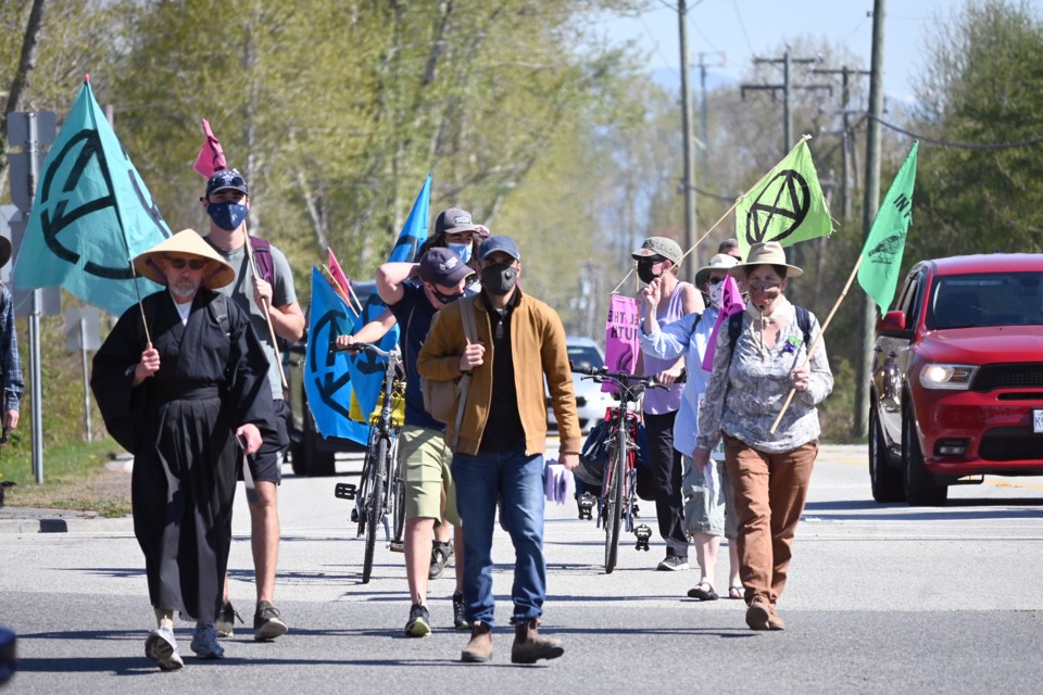 After disembarking from the bus provided by the City of Richmond on Saturday, demonstrators with Extinction Rebellion Vancouver continued their walk through Delta to the ferry terminal. This is the second day of their four-day trek.