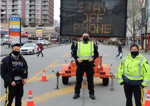 Richmond RCMP with a large sign warning drivers to get off their phones.