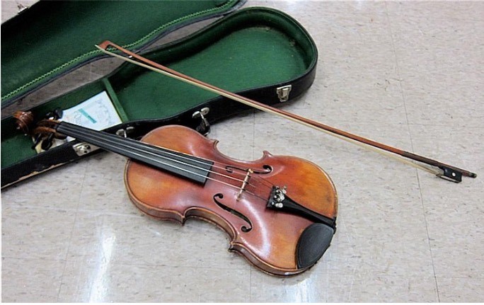 A vintage violin fell out of a vehicle near Francis and Gilbert roads on Wednesday, July 16.