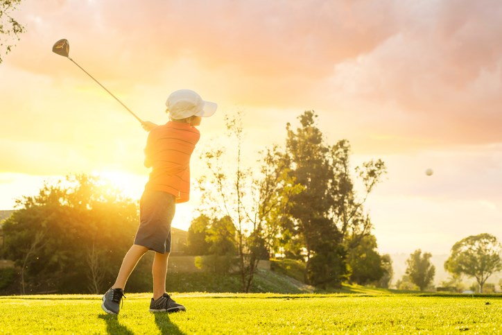 Kid golfing