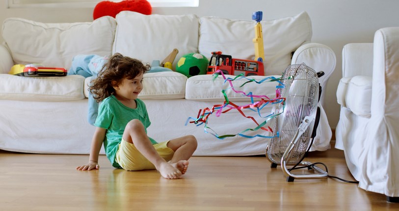 Kid in front of a fan