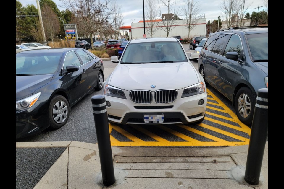 A white BMW was parked next to a van accessible spot on Saturday afternoon.
