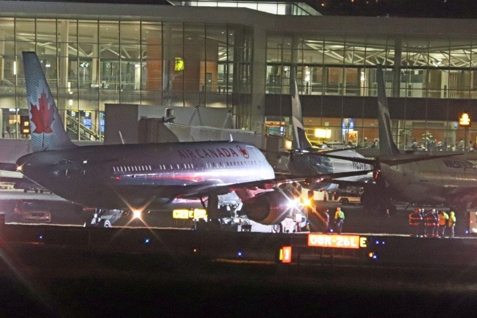 An Air Canada plane had to be towed at YVR after becoming stuck in muddy grass.