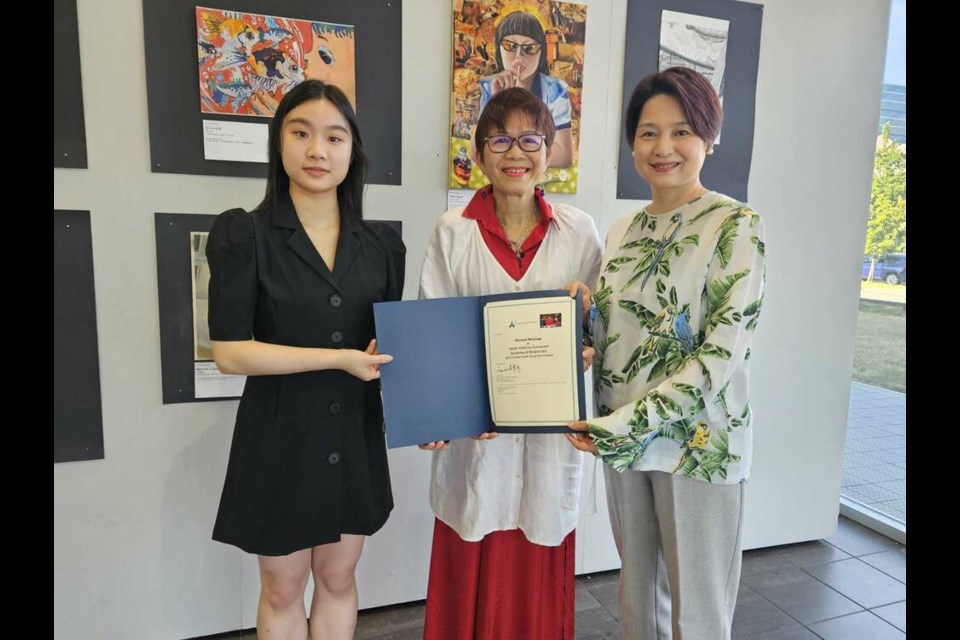 Yoshier Hu (left), a Richmond student and co-president of Youth Initiative Vancouver, is at the display at Lipont Place with contest president Maggie Li (right) and Richmond Centre MLA Teresa Wat. Photo submitted 