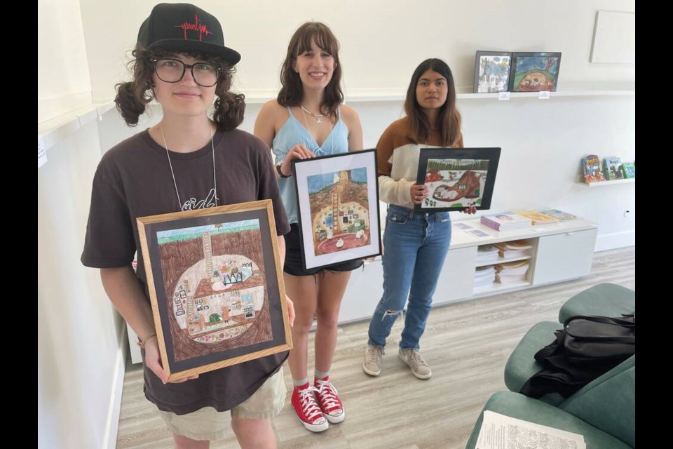 Grade 10 Hugh Boyd students (left to right) Ryan Monaghan, Livia Novak and Michel Santana Miranda displayed their 'Winter Burrow' art at MLA Kelly Greene's office. Maria Rantanen photo