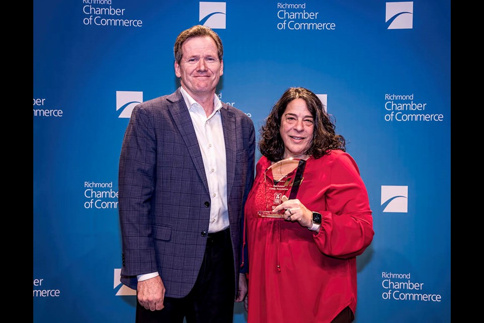  Judy Valsonis accepts the award for Touchstone Family Association, presented by Mike McNaney from the Vancouver Airport Authority. Chung Chow photo 