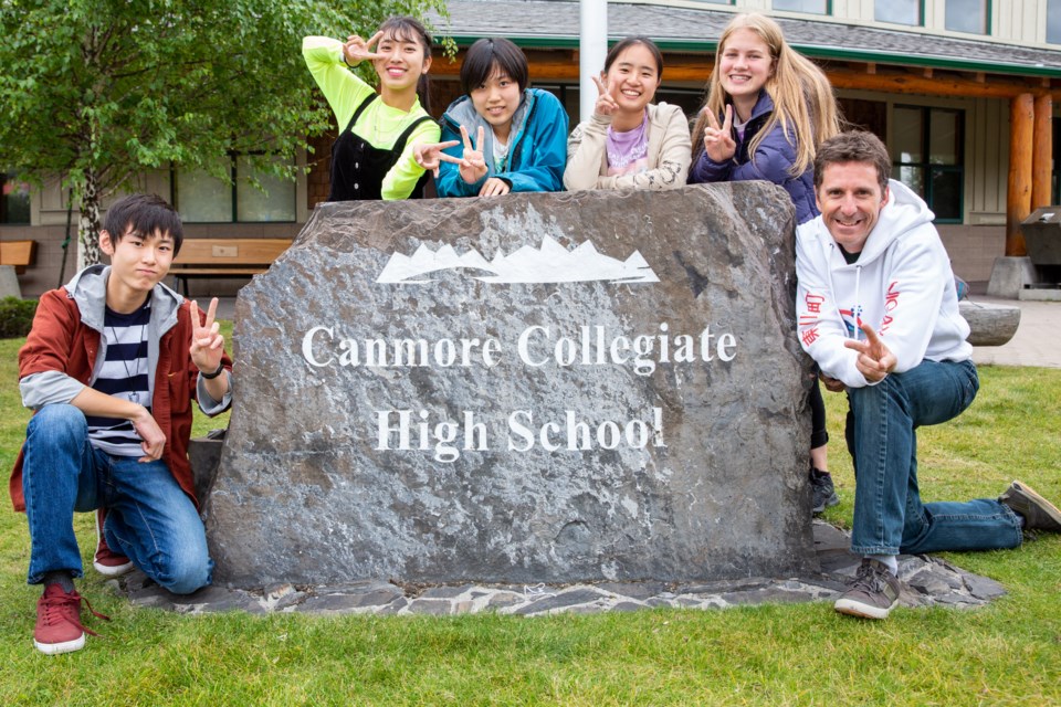 Japanese exchange students Shunshuke Nishimura, left, Karen Ishikawa, Amane Habuki,  Mikoto Okazaki, Canomore Colligate student Anika Gasser and teacher Ken Symington pose in front of the Canmore Colligate High School on Sept. 18. The four exchange students, who are from Higashikawa, Canmore's sister-city in Japan, spent two weeks in the Bow Valley. Evan Buhler RMO PHOTO