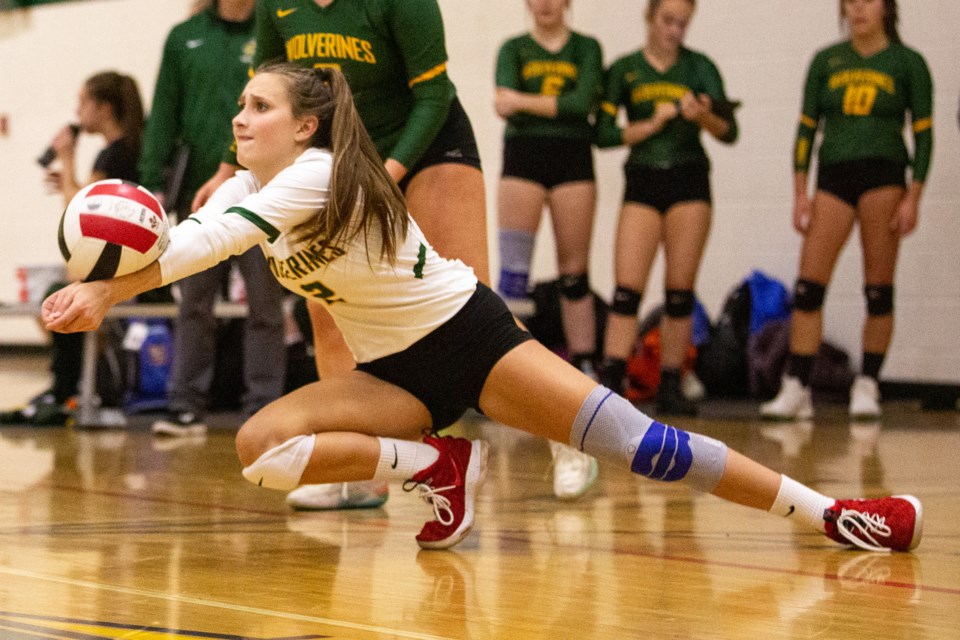 Evvia Belireau dives to make a pass during a Canmore Wolverines home game at Canmore Collegiate High School. RMO FILE PHOTO