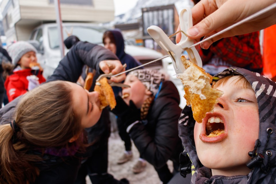 Toby Glynn chows down at the Beavertail eating contest at the Canmore Winter Carnival in February 2020. RMO FILE PHOTO