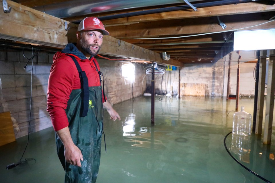 Exshaw resident Brent Peters stands in his basement after it was flooded with more than 35 centimetres of water on Tuesday (June 2). Peters said water continues to flow into the basement, and expects the room to flood completely within a few days. Flooding issues started more than 10 days ago and more than 25 homes have been affected in the hamlet. EVAN BUHLER RMO PHOTO⁠