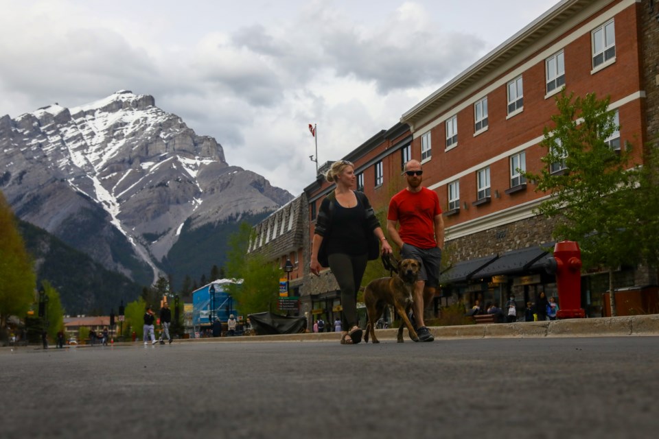 Pedestrians walk down the middle of Banff Avenue. RMO FILE PHOTO⁠