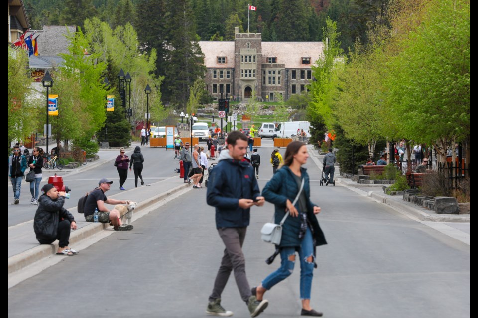 Pedestrians walk down the middle of Banff Avenue on Friday (June 5). On Friday the 100 and 200 blocks of Banff Avenue and a portion of Caribou Street were closed to traffic to make more room for people on foot to be able to physically distance due to COVID-19. EVAN BUHLER RMO PHOTO⁠