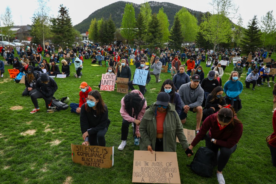 Two women hold hands during a moment of silence at the Banff Supports BLM Vigil in Central Park on Saturday (June 6). More than 600 supporters marched down Banff Avenue in support and solidarity with local Black, Indigenous, and People of Colour (BIPOC) community. Anti-racism protests have swept across the globe in response to the disproportionate number of killings of black citizens by police officers in the U.S. EVAN BUHLER RMO PHOTO⁠