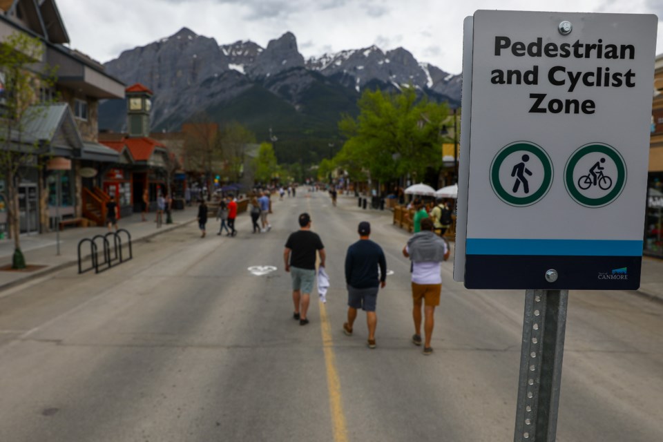 Pedestrians walk down Main Street in Canmore in June. The Town of Canmore closed Main Street to vehicle traffic help ease social distancing between pedestrians due to COVID-19. EVAN BUHLER RMO PHOTO⁠