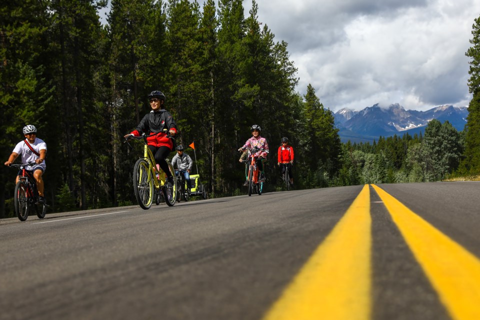 A family cycles along the Bow valley Parkway towards Johnston Canyon on Saturday (Aug. 8). The highway has been closed to visitor vehicle traffic this summer allowing pedestrians and cyclists to take over. EVAN BUHLER RMO PHOTO