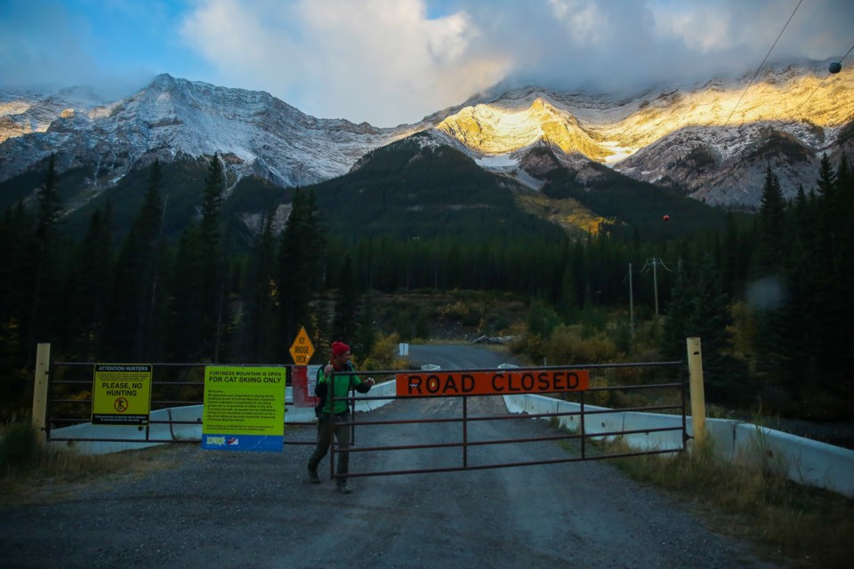 White Mountain Adventures guide Sam Campeau opens up the gate to Fortress Mountain on Saturday (Sept. 26). EVAN BUHLER RMO PHOTO