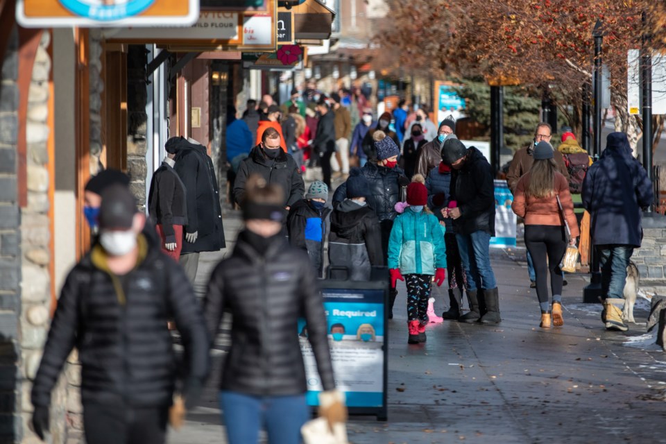 Hundreds of pedestrians walk along Banff Avenue on Saturday (Nov. 28). The Town of Banff declared a state of local emergency in tandem with the measures enacted under the Provincial Public Health Emergency, to stop the spread of COVID-19. EVAN BUHLER RMO PHOTO