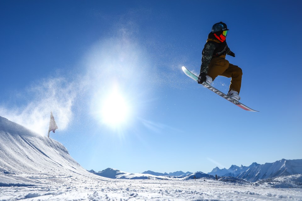 A snowboarder performs a massive tail grab at Sunshine Village Ski Resort in December 2021. RMO FILE PHOTO