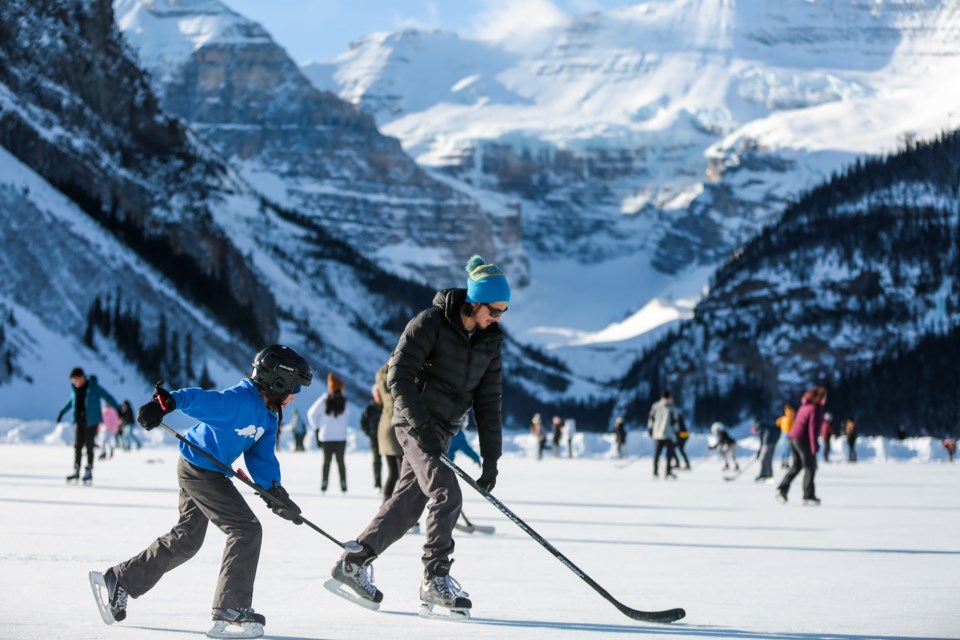 Gerard Landero and his son Julian play a game of keep away on Lake Louise in Banff National Park on January this year. EVAN BUHLER RMO PHOTO