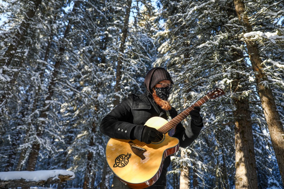 Kasey Nolan wears a musically inspired mask while playing guitar as a symbol of his recently released instrumental album The Voiceless. 	EVAN BUHLER RMO PHOTO