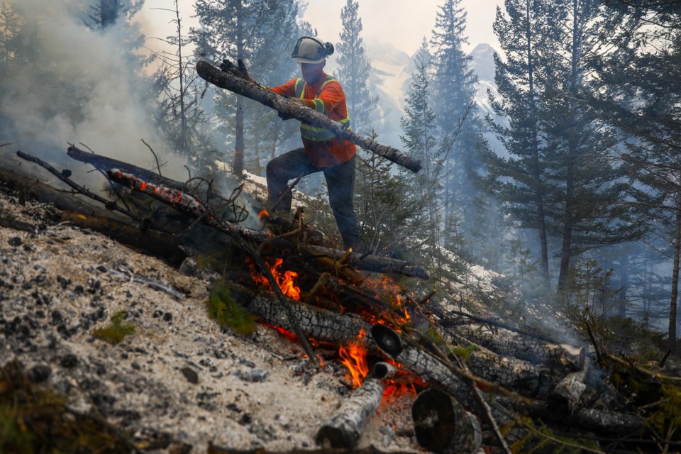 Matt Mueller of Alpine Precision Tree Services Ltd. tends to a prescribed fire during a FireSmart procedure for Silvertip Resort near Benchlands Trail on Tuesday (March 2). The controlled burn helps to mitigate the chances of wildfires in the summer. RMO FILE PHOTO