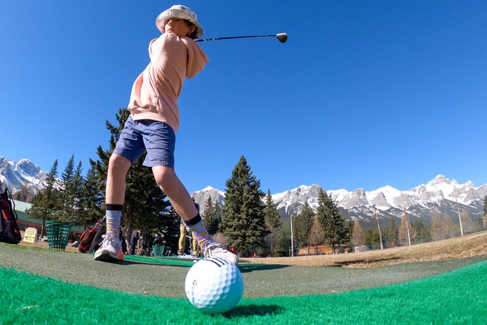Issaac Riep keeps his eye on the ball as he prepares to hit the golf ball at the Canmore Golf and Curling Club driving range in 2021. RMO FILE PHOTO