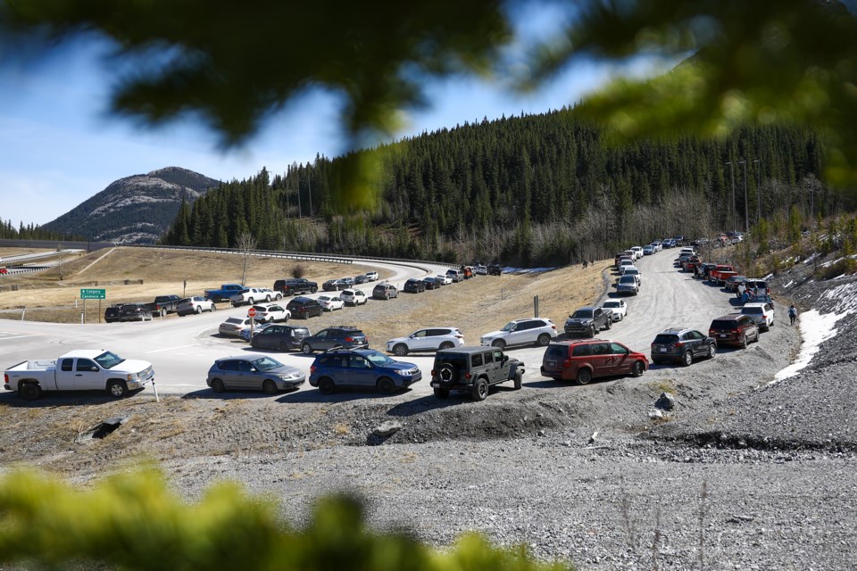 Several dozen cars park along the Lac des Arcs highway exit and along the road to the Heart Creek trail head parking lot in April 2021.

RMO FILE PHOTO