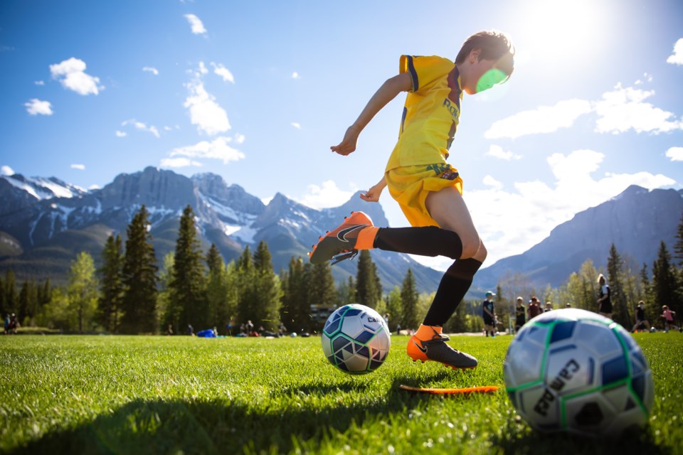 Ryan Orchard completes a ball control drill during Canmore Minor Soccerâs return to field event at Millennium Field on Tuesday (June 1). Children were divided into age groups and into smaller groups of eight during the first practice of the year. EVAN BUHLER RMO PHOTO