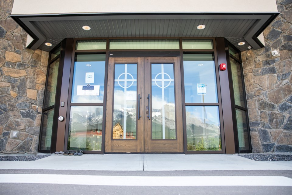 Three pairs of shoes left in front of The Shrine Church of Our Lady of the Rockies as a memorial for the 215 children found in a mass grave on the grounds of the Kamloops Residential School on Tuesday (June 8). EVAN BUHLER RMO PHOTO