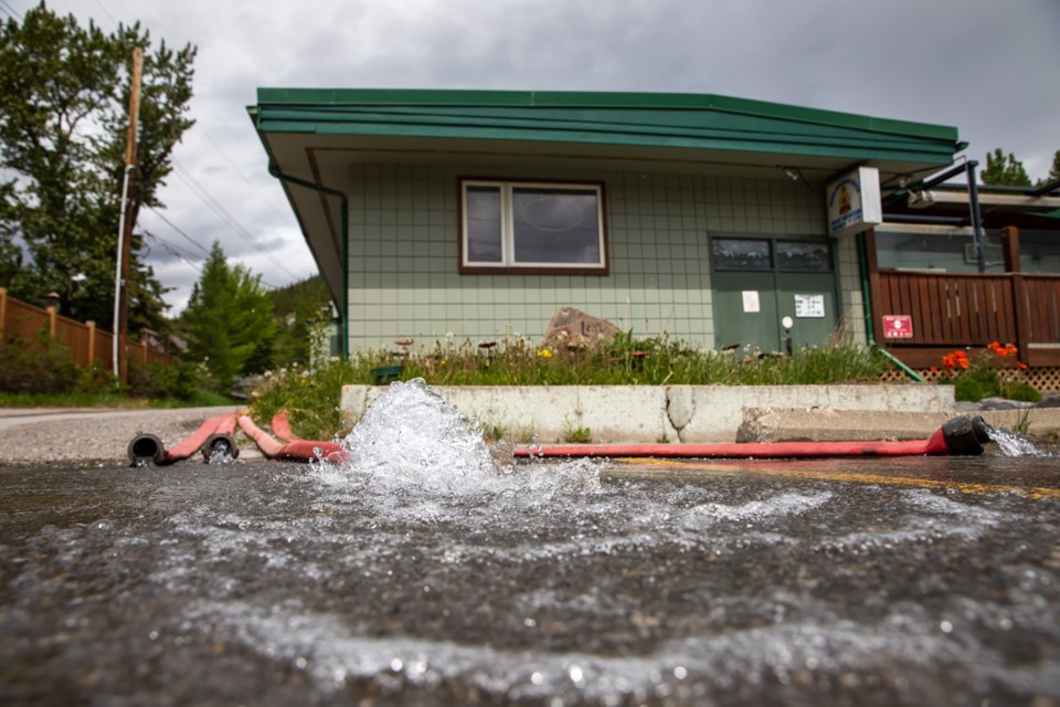 Water is pumped out of the basement of the Exshaw Community Centre on Tuesday (June 8). 

RMO FILE PHOTO