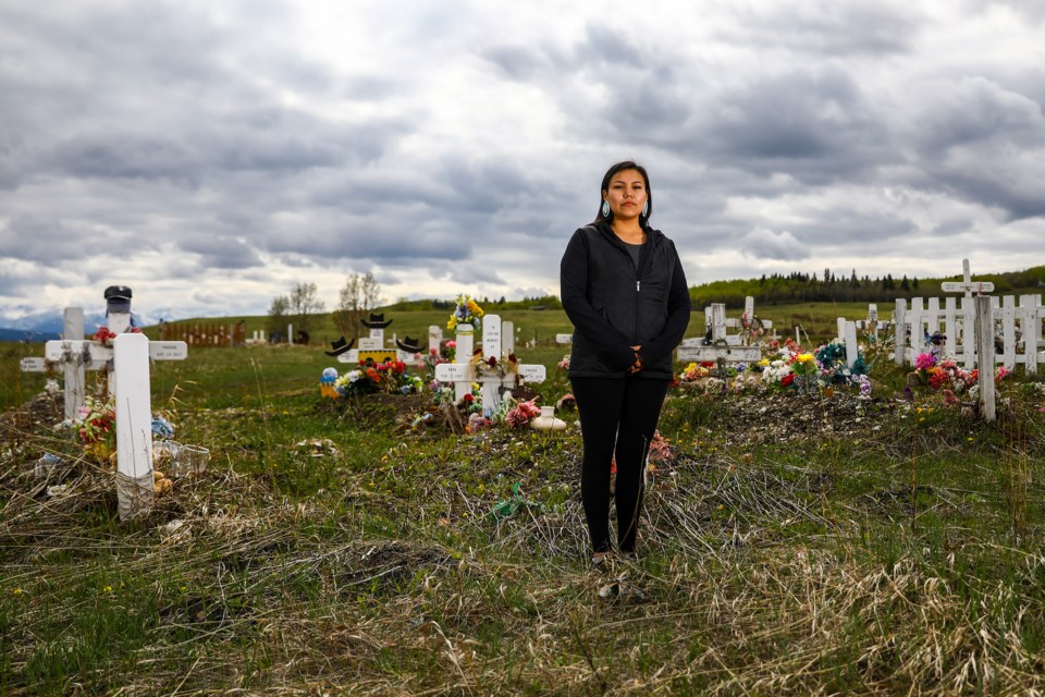 Summer Twoyoungmen of the Stoney Nakoda First Nation, and activist against drug dealers and organizer of the Battle Against Drugs Walk, stands in the Wesley Cemetery where her mother, who died of a drug overdose, is buried. 	EVAN BUHLER RMO PHOTO