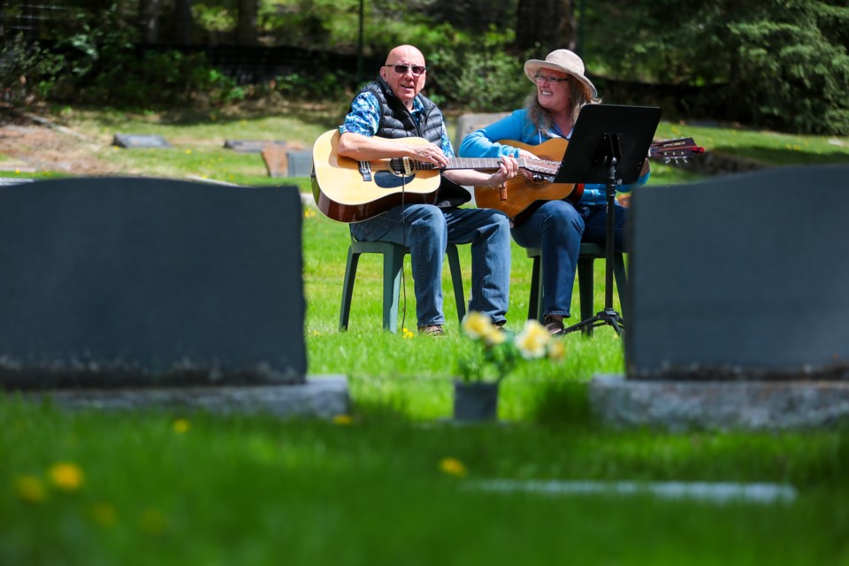 Shane Coultis Sr, left, and Liz Wilson sing a number of songs on Saturday (June 12) for Coultis' grandmother Minnie Davidson, who is buried in the in the Old Banff Cemetery. EVAN BUHLER RMO PHOTO