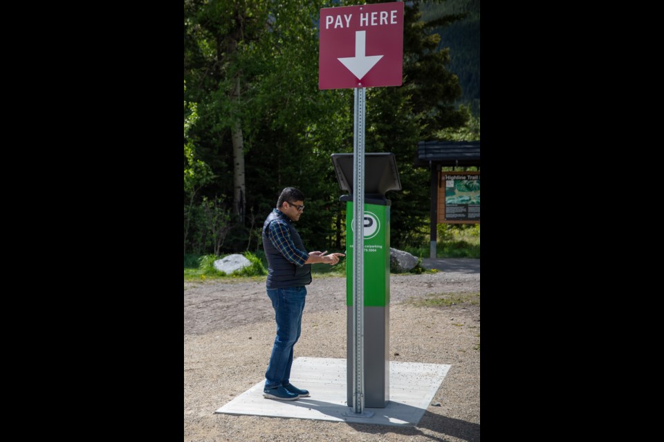 A tourist pays for parking at the newly operational paid parking lot at Quarry Lake Park on Saturday (June 12). EVAN BUHLER RMO PHOTO