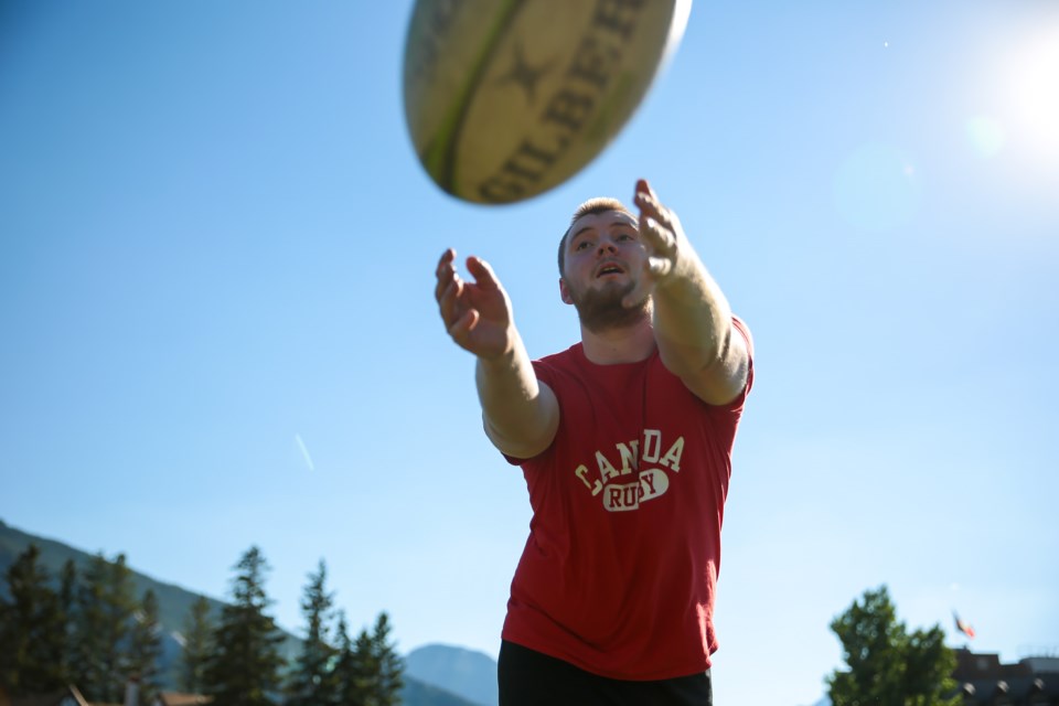 James van Dorsten passes the ball while warming up during the first practice of the 12-week rush rugby program at the Banff Community High School field on Wednesday (June 30). The five-on-five, non-contact version of the sport will have players wear a flag belt around the waist, similar to flag football, for ages 15 and up. EVAN BUHLER RMO PHOTOENTER DESCRIPTION on Wednesday (June 30). EVAN BUHLER RMO PHOTO