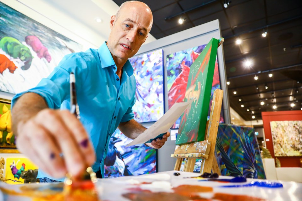 Calgary-based artist Keith Dalgleish paints during an artist demo at Avens Gallery in Canmore on Saturday (July 17). EVAN BUHLER RMO PHOTO