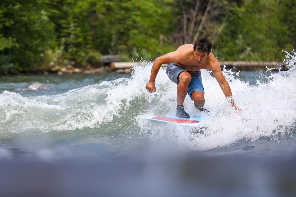 River surfer David Manning rides the Mountain Wave in the Kananaskis River in Kananaskis Country on Saturday (July 17). EVAN BUHLER RMO PHOTO