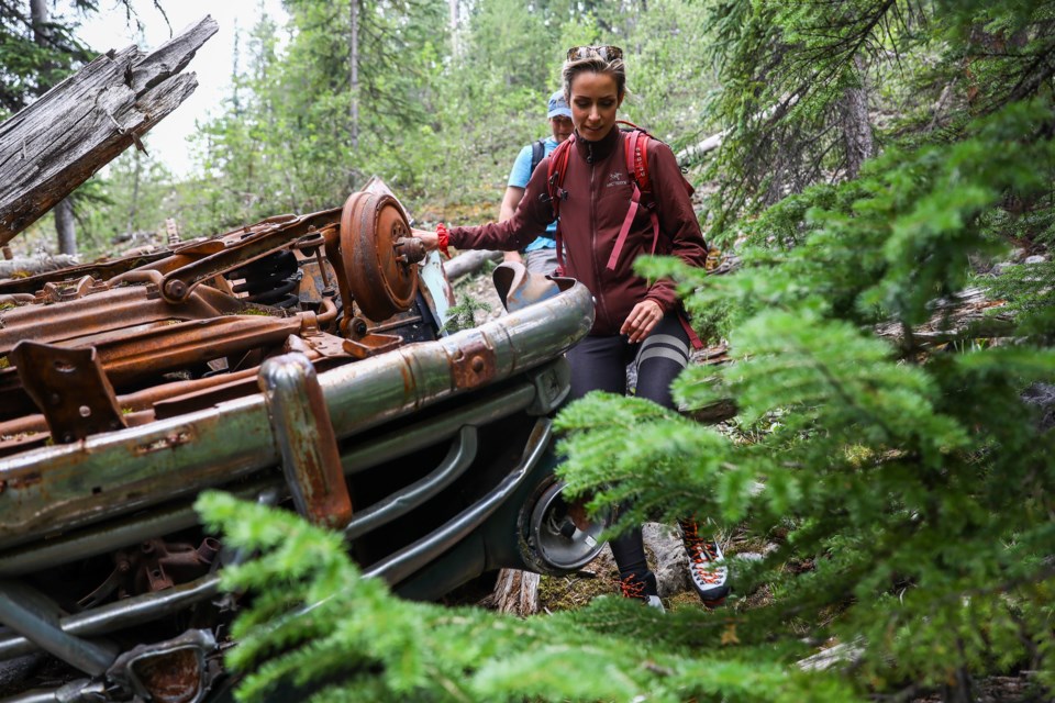 Freedivers Lorenza Malaguti and Olivier Aubin walk around an overturned wreck of a 1952 Hudson as they bushwhack to try and find a secret diving location in a slot canyon near the Columbia Icefields on Friday (July 23). EVAN BUHLER RMO PHOTO
