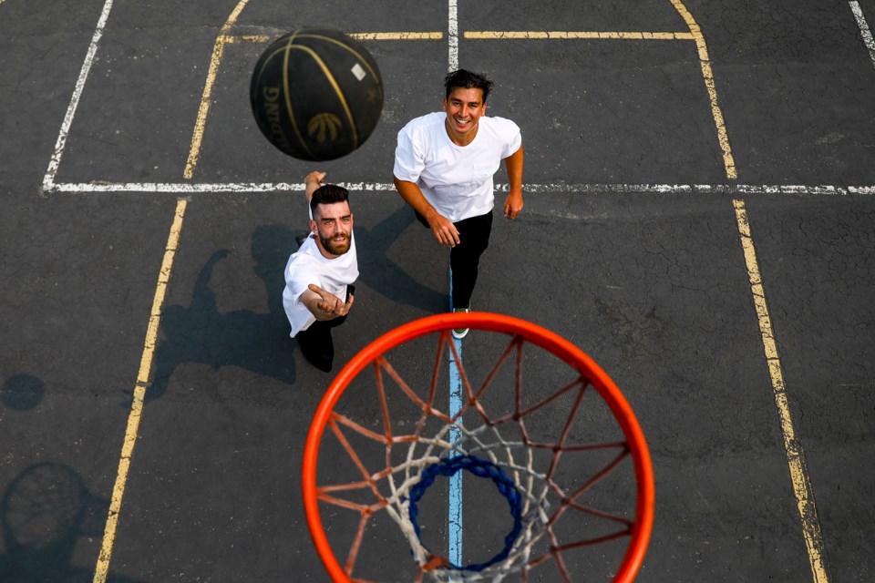Chris Langlois, left, shoots a layup during a one-on-one basketball game against Francisco Cruz at the Cougar Creek basketball court on Thursday (July 29). EVAN BUHLER RMO PHOTO