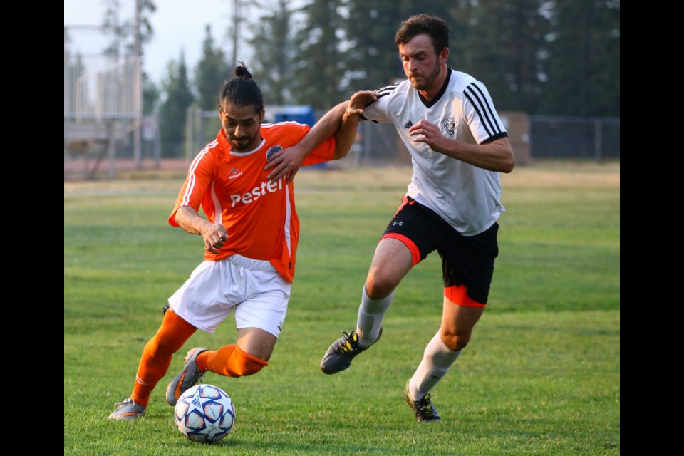 Hector Navarro, left, of Rundle FC makes a move as he dribbles past Earl's/Banff Springs centre back Harry Goodship during a at Our Lady of the Snows field on Thursday (Aug. 5). Earl's/Banff Springs won the high scoring match 6-5. EVAN BUHLER RMO PHOTO