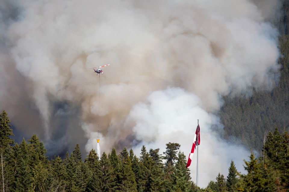 Alberta Wildfire helicopters aerially assists firefighters on the ground as a wildfire burns at the base of Pigeon Mountain near Dead Man's Flats on Friday (Aug. 13). At 6:30 p.m. the fire was approximately 10 hectares and out of control. East and westbound traffic on the Trans-Canada Highway was shut down. EVAN BUHLER RMO PHOTO