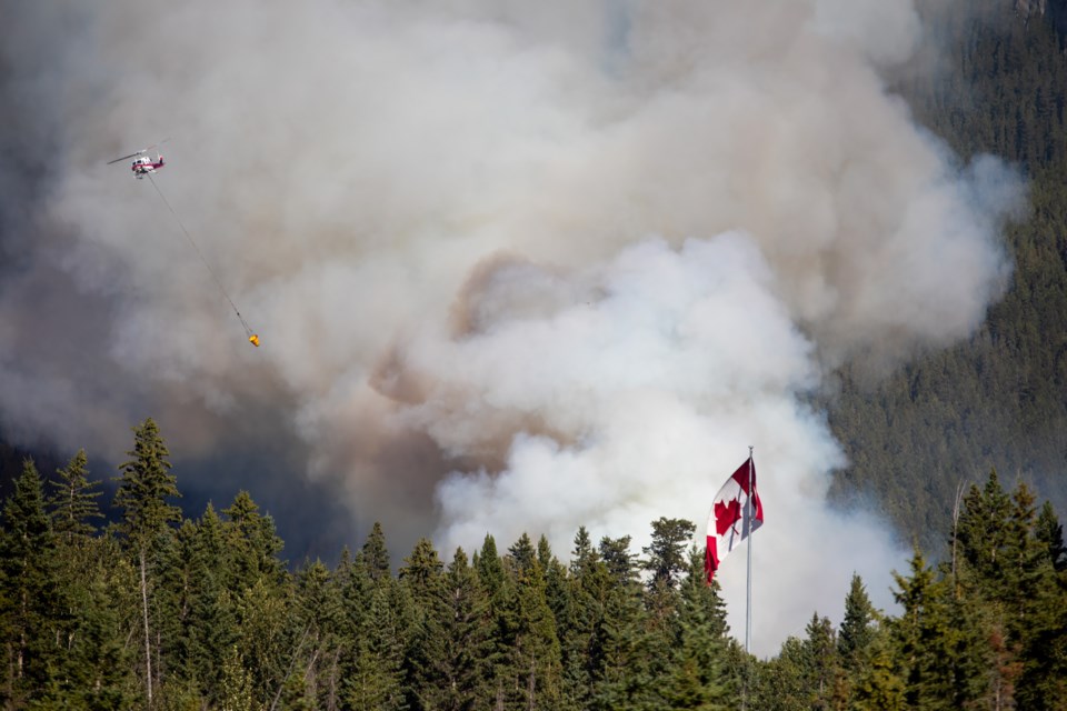 Alberta Wildfire helicopters assist firefighters on the ground as a wildfire burns at the base of Pigeon Mountain near Dead Man's Flats in 2021. 
RMO FILE PHOTO